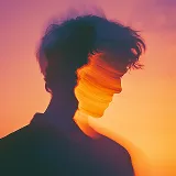 Silhouette of a person with a double-exposure effect against a colorful orange and pink sky.