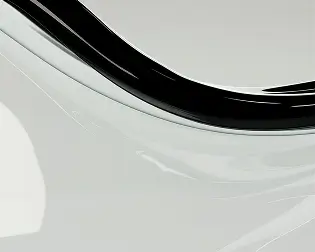 Close-up of a smooth, curved black and white glossy surface with reflective highlights.